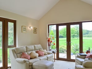 Sets of doors lead to impressive garden from the living area | Moorland Lodge, Holt Wood, near Wimborne