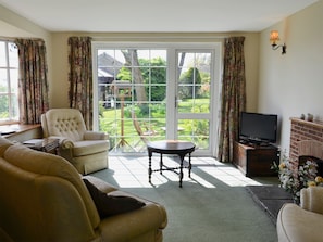 Relaxing living room with patio doors leading to the garden | Burrow Farm Garden Retreat - Valley View - Burrow Farm Gardens Retreat, Dalwood, near Axminster