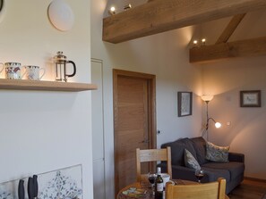 Open plan living space with wood burner | The Hayloft - Netherfield Hill Farm, Netherfield, near Battle