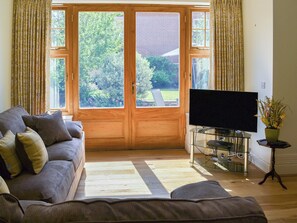 Lovely living/dining room with French doors to garden | Three The Boulevard, Sheringham