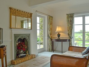 Light and airy living and dining room with French doors leading to garden | Acorn Cottage, Todenham, near Moreton-in-Marsh