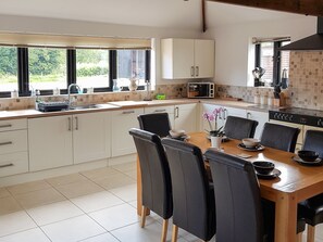 Convenient dining area within a well-equipped kitchen | Summer House Stables, Catfield, near Stalham