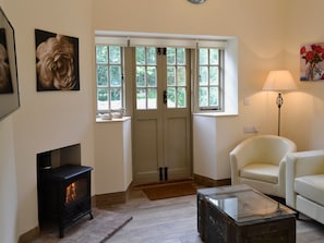Cosy living room with French doors leading to garden | Whatley Lodge, Winsham, near Chard