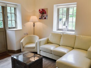 Cosy living room with French doors leading to garden | Whatley Lodge, Winsham, near Chard