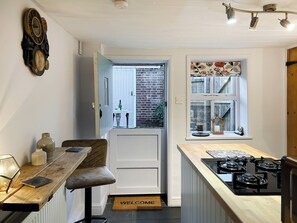 Kitchen door leads out to the rear courtyard | Time Cottage, Coltishall, near Wroxham
