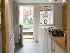 Kitchen door leads out to the rear courtyard | Time Cottage, Coltishall, near Wroxham