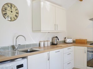 Spacious and bright, the kitchen has exposed woodwork and sloping ceilings | Garden Cottage, Ugborough, near Ivybridge