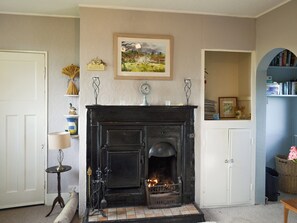 Heritage feature fireplace within the living room | Searchlight Cottage, Fraisthorpe, near Bridlington