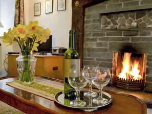 Homely living room with an open fire | Rowlandson Ground Cottage, Coniston