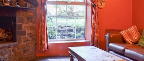 Slate-floored living room with open fireplace | Birkerthwaite Barn - Birkerthwaite Cottages, Eskdale