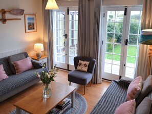 French doors from the living room lead onto a delightful terrace | Violet Cottage, Kingsdown, near Deal