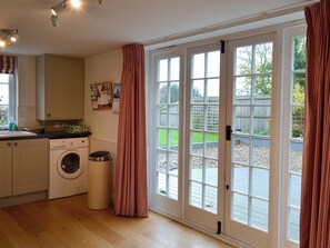 French doors from the kitchen lead onto a delightful terrace | Violet Cottage, Kingsdown, near Deal