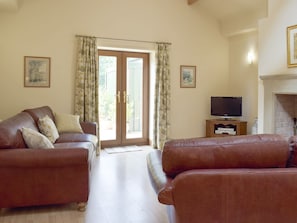 Attractive living area with French doors to patio | Woodpecker Cottage - Corgill Farm Cottages, Bolton-by-Bowland