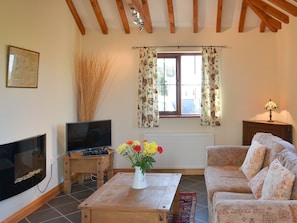 Beamed living room with contemporary electric fire | Beckaveans Stable - Beckaveans, Jacobstow, near Bude