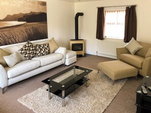 Living room with wood burning stove | Hafan Dawel, Stepaside, near Saundersfoot