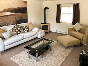 Living room with wood burning stove | Hafan Dawel, Stepaside, near Saundersfoot