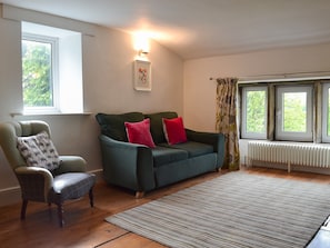 Wooden-floored living area with double sofa bed | Pear Tree House Annexe, Wooldale, near Holmfirth