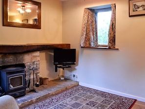 Wood-floored living room with wood-burning stove | The Cot, Bussage, near Cirencester