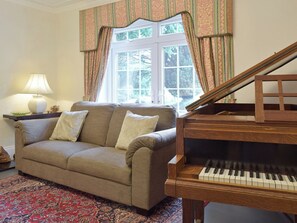 Furnishings in the living room include a grand piano | Tan Y Castell, Llanmill, near Narberth