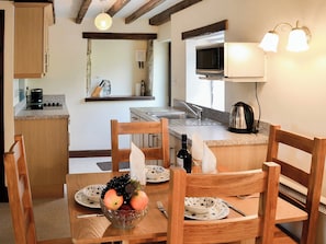 Dining area and adjacent kitchen | Swaledale Cottage - Swaledale and Ellerbeck Cottages, Caldbeck, near Keswick
