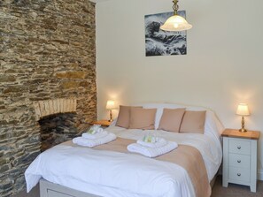 Cosy and inviting double bedroom with feature stone wall | Rosetta ApartmentsOcean Mist, Newquay