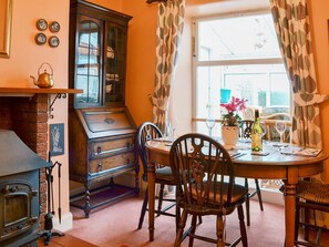 Delightful dining room with window onto the conservatory | Shingle Cottage, Seascale, near Eskdale
