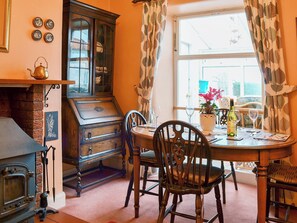 Delightful dining room with window onto the conservatory | Shingle Cottage, Seascale, near Eskdale