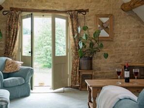 Lving room french doors leading to the garden | Flowers Barn, Middle Duntisbourne, near Cirencester