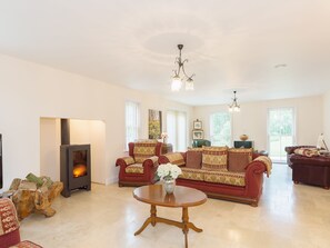 Tile-floored living room with wood burner | Yokefleet Cottage, Sandholme, near Beverley