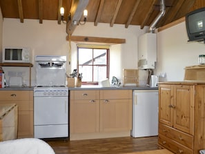 Well-equipped fitted kitchen within open-plan living space | The Byre, Newby, near Appleby-in-Westmorland