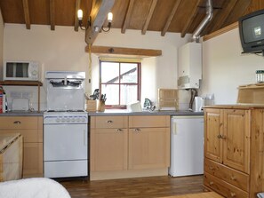 Well-equipped fitted kitchen within open-plan living space | The Byre, Newby, near Appleby-in-Westmorland