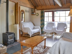 Wood burner in lounge area of open-plan room | The Byre, Newby, near Appleby-in-Westmorland