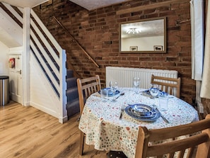 Comfortable leather chairs and wooden floor in the living area | Yarlington Mill - The Old Kennels Holidays, Ledbury