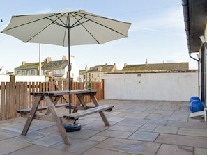 Paved patio area with outdoor furniture | Porthole Cottage, Allonby, near Maryport