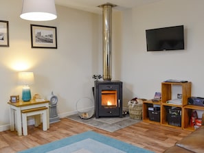 Cosy living area with wood burner | Porthole Cottage, Allonby, near Maryport