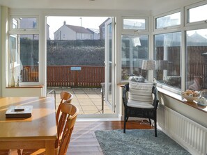 Dining area in the sun room | Longstone Bungalow, Beadnell