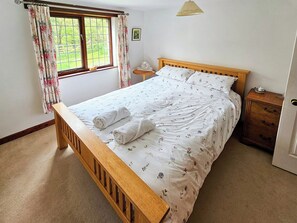 Kingsize bed with views out over the woods | Wringford Farm Annexe, Rame, Torpoint