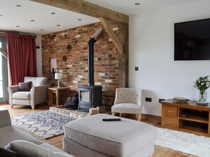Living space with wood burner and exposed brick | Henry Oscar House, Winchelsea, near Rye