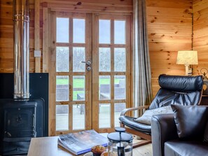 Wood-floored living area with doors to the decked area | Halfmoon Wood - Readyfields Farm, Caunton, near Newark