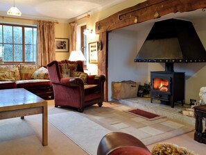 Cosy and warn living room with a large inglenook | Cleiriach, Llansannan, near Betws-y-Coed