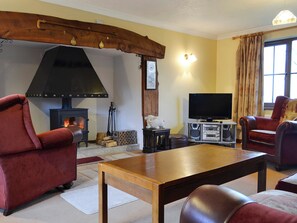 Cosy and warn living room with a large inglenook | Cleiriach, Llansannan, near Betws-y-Coed