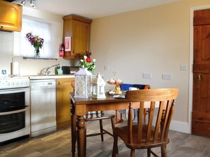 Kitchen and dining area with open fire | Buckswell Cottage, Baldersdale, near Barnard Castle