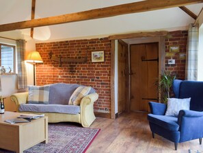 Cosy beamed living area with a wood burner | Chick Hatch Barn, Carlton, near Saxmundham