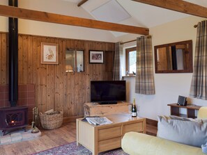Cosy beamed living area with a wood burner | Chick Hatch Barn, Carlton, near Saxmundham