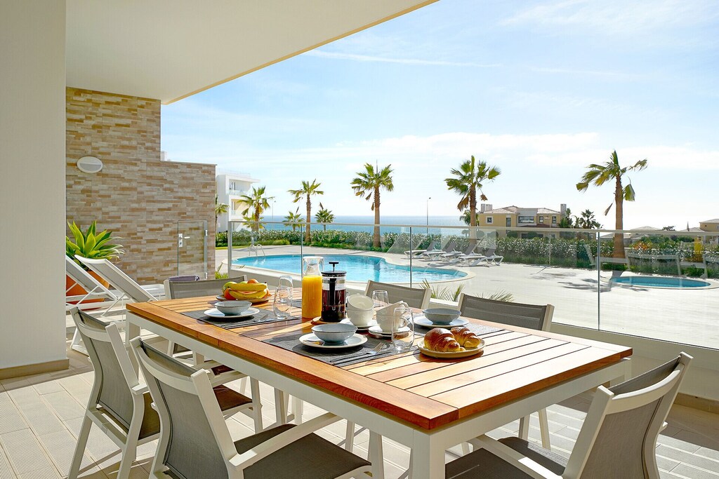 Breakfast table on the terrace of a Lagos rental condo overlooking the swimming pool