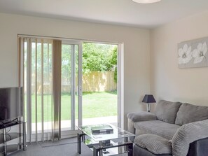 Stylish living area with patio door to garden | Jasper, Broadstone, near Bournemouth