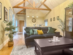 Spacious living area with exposed wooden roof trusses | Sykelands Cottage - Sykelands Grange Cottages, Dalton