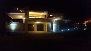 Villa at night - double garage doors 