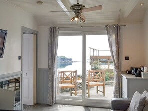 Open-plan living area with sliding door to patio area | Misty Isles Cottage - Misty Isles Cottages, Ellenabeich, Seil Island