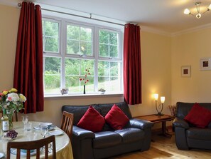 Spacious living/dining room with electric woodburner and wooden floor | Laundry Cottage, Ceannacroc